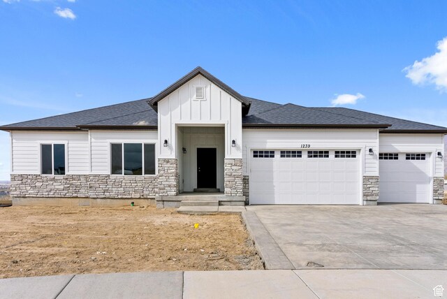 2363 E 370 N Unit 07, Spanish Fork, UT 84660 - view of front of property featuring stone siding, a garage, board and batten siding, concrete driveway, and roof with shingles