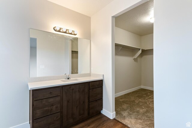 2363 E 370 N Unit 07, Spanish Fork, UT 84660 - bathroom with vanity, baseboards, wood finished floors, and a walk in closet