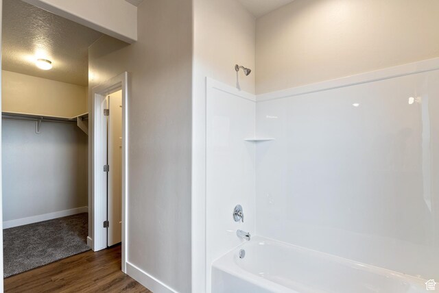 2363 E 370 N Unit 07, Spanish Fork, UT 84660 - bathroom featuring wood finished floors, shower / bathtub combination, baseboards, and a spacious closet