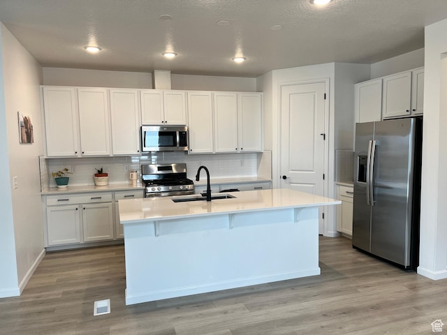2055 S 4140 W, Taylor, UT 84401 - kitchen with stainless steel appliances, a sink, white cabinetry, and recessed lighting