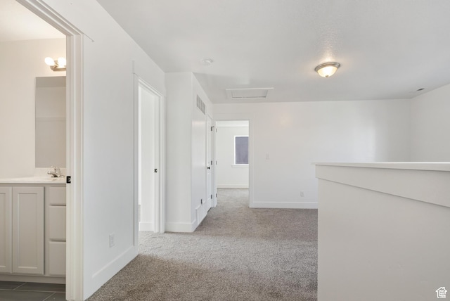 hall with carpet and baseboards