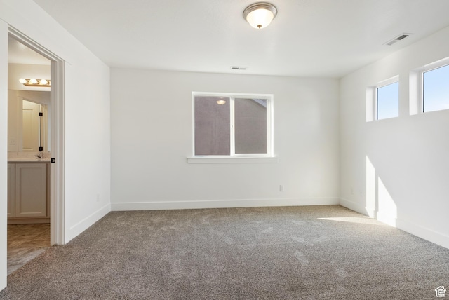 spare room with carpet floors and baseboards