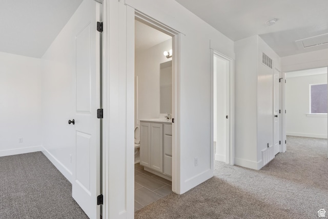 corridor with carpet and baseboards