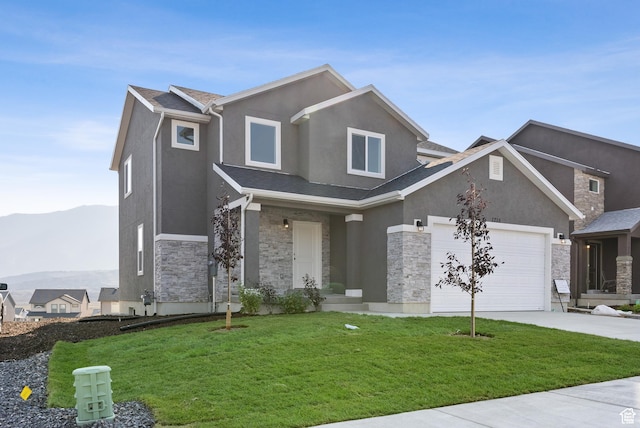 view of front of house featuring stone siding, stucco siding, a front lawn, driveway, and an attached garage