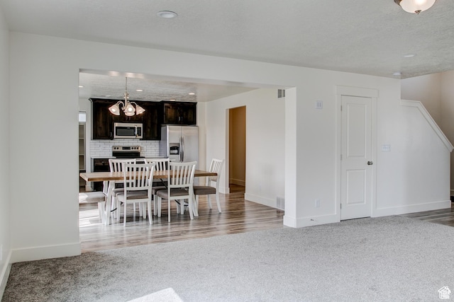 362 N 2350 E Unit 10, Spanish Fork, UT 84660 - dining space with light colored carpet, baseboards, a chandelier, and a textured ceiling