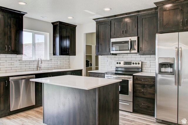 362 N 2350 E Unit 10, Spanish Fork, UT 84660 - kitchen featuring stainless steel appliances, a sink, backsplash, light countertops, and light wood-style flooring