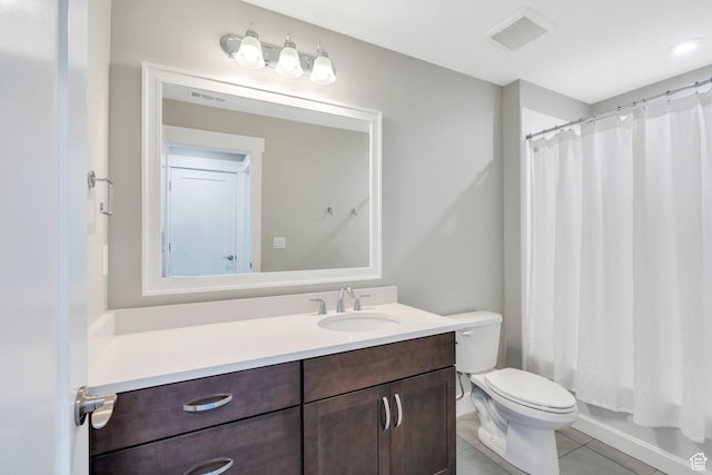 bathroom with tile patterned flooring, vanity, and toilet