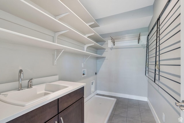 laundry room with electric dryer hookup, washer hookup, light tile patterned flooring, and baseboards