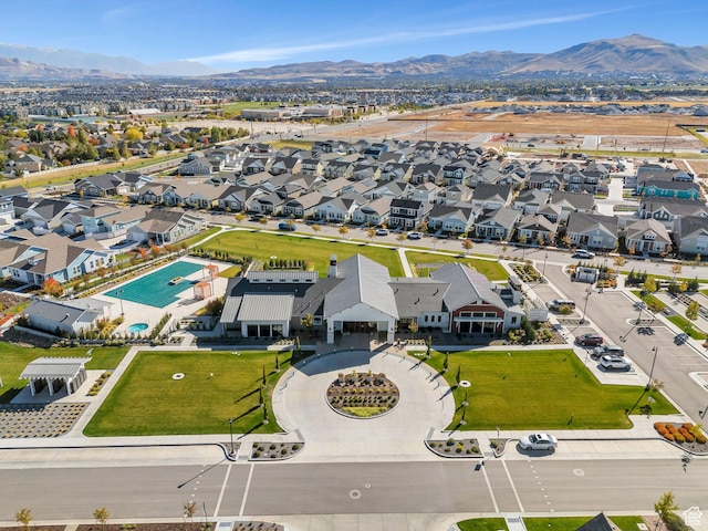 aerial perspective of suburban area featuring a pool and mountains