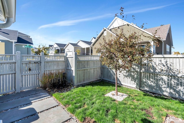 view of yard featuring a gate and a residential view
