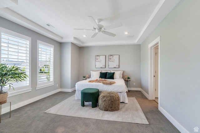 bedroom featuring carpet, recessed lighting, baseboards, a raised ceiling, and a ceiling fan