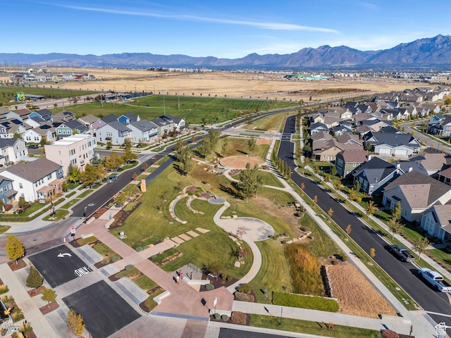 aerial view of property and surrounding area with a mountain backdrop and nearby suburban area