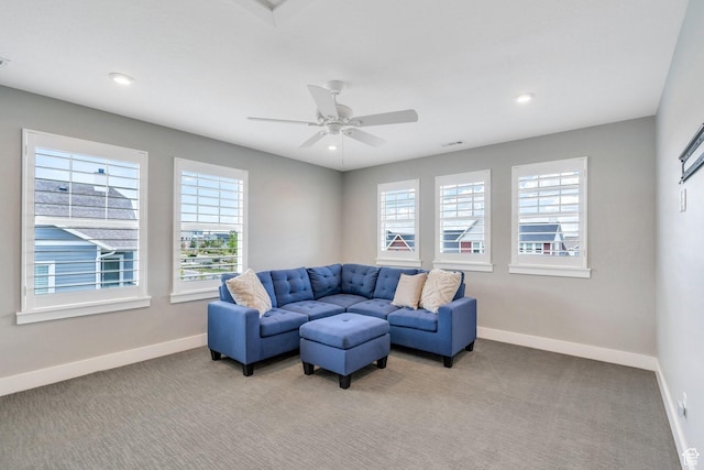 living area featuring plenty of natural light, baseboards, light carpet, and recessed lighting