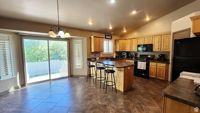 kitchen featuring black appliances, dark countertops, a breakfast bar, healthy amount of natural light, and lofted ceiling