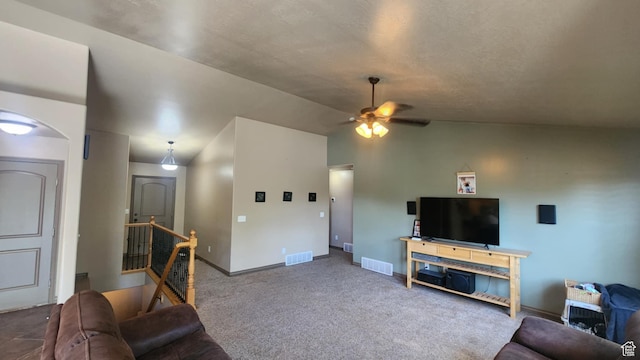living room featuring ceiling fan, carpet, baseboards, vaulted ceiling, and arched walkways