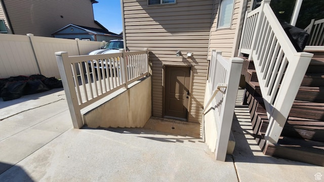 view of exterior entry featuring fence