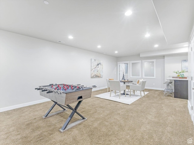 rec room with recessed lighting, light carpet, and baseboards