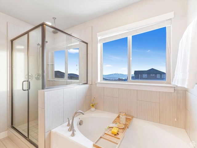 full bath featuring a stall shower and a garden tub