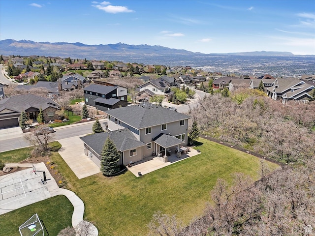aerial view of residential area featuring mountains