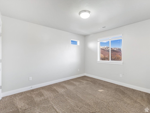 unfurnished room with carpet flooring and baseboards