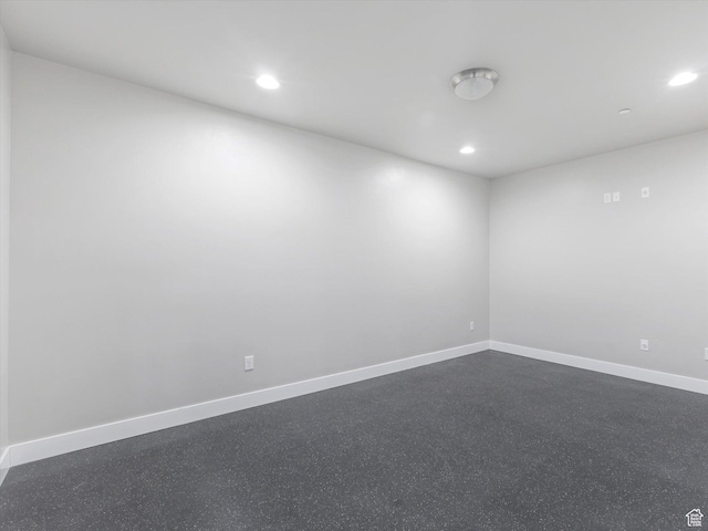 empty room with recessed lighting and baseboards
