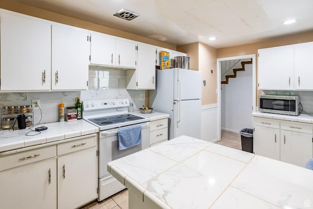 853 N 1250 W, Provo, UT 84604 - kitchen with white appliances, tasteful backsplash, white cabinets, recessed lighting, and tile countertops