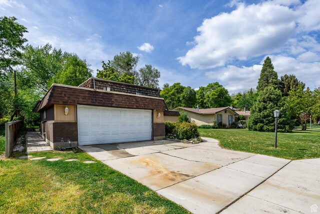 853 N 1250 W, Provo, UT 84604 - view of front facade with brick siding, a front yard, mansard roof, concrete driveway, and view of wooded area