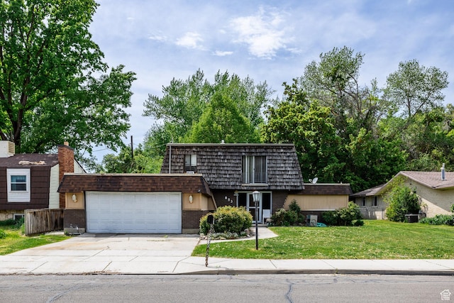 853 N 1250 W, Provo, UT 84604 - front facade featuring mansard roof, an attached garage, concrete driveway, and brick siding
