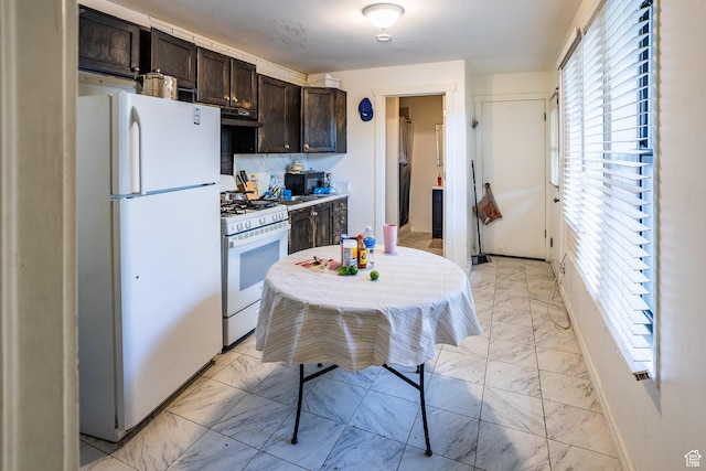 853 N 1250 W, Provo, UT 84604 - kitchen with white appliances, light marble finish floors, dark brown cabinets, under cabinet range hood, and light countertops