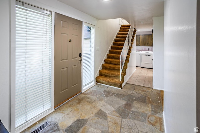 853 N 1250 W, Provo, UT 84604 - foyer entrance with washing machine and clothes dryer, stone tile floors, and stairway