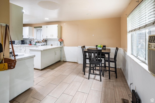853 N 1250 W, Provo, UT 84604 - kitchen with plenty of natural light, white cabinets, tile counters, and wood finish floors