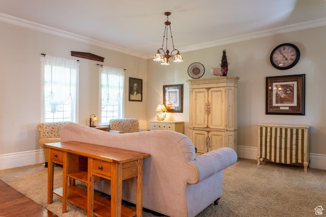 living area with ornamental molding, baseboards, and a chandelier