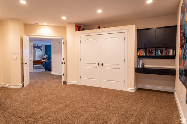 unfurnished bedroom featuring carpet, a closet, recessed lighting, and baseboards