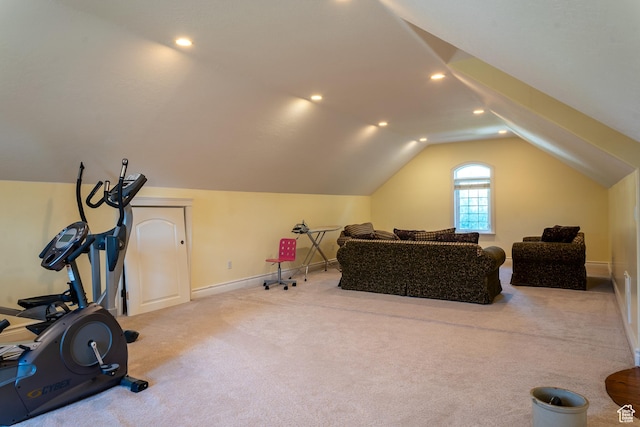 exercise room featuring vaulted ceiling, carpet floors, and baseboards