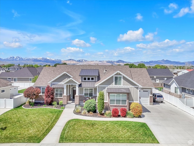 11896 S Verde View Cv, Riverton, UT 84065 - craftsman-style home with board and batten siding, concrete driveway, a standing seam roof, and a mountain view