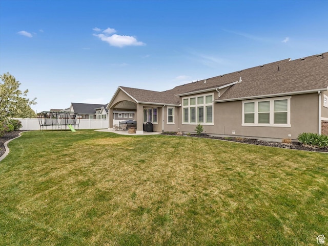 11896 S Verde View Cv, Riverton, UT 84065 - back of property with a patio, a trampoline, a fenced backyard, stucco siding, and roof with shingles