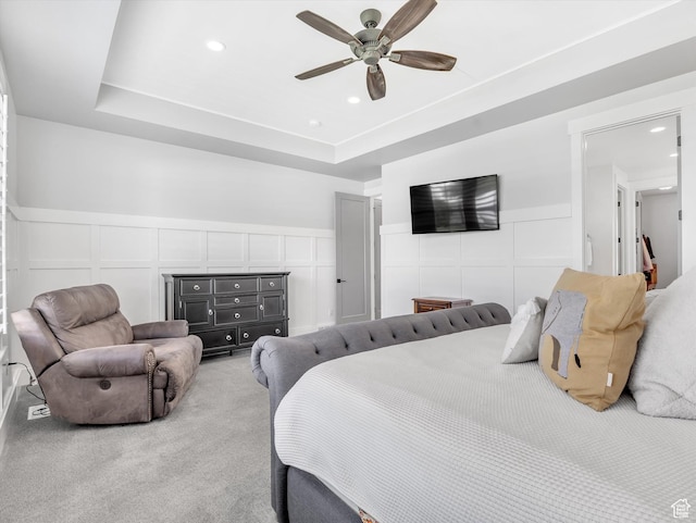 11896 S Verde View Cv, Riverton, UT 84065 - bedroom featuring a decorative wall, wainscoting, ceiling fan, light colored carpet, and a tray ceiling