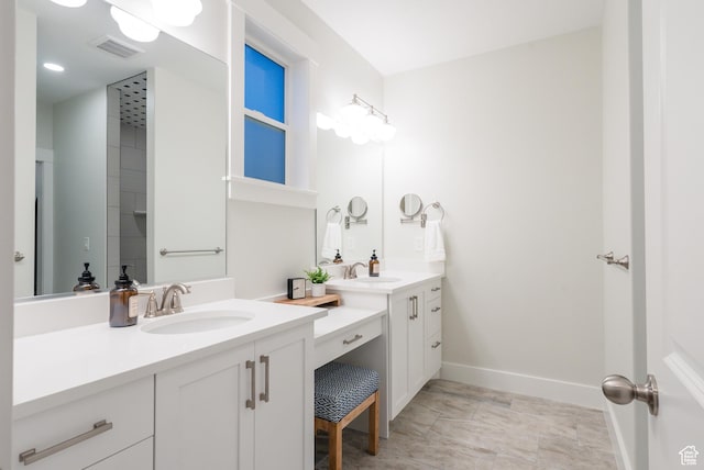 bathroom with two vanities, baseboards, and recessed lighting