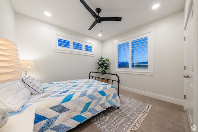 carpeted bedroom featuring baseboards, recessed lighting, and a ceiling fan