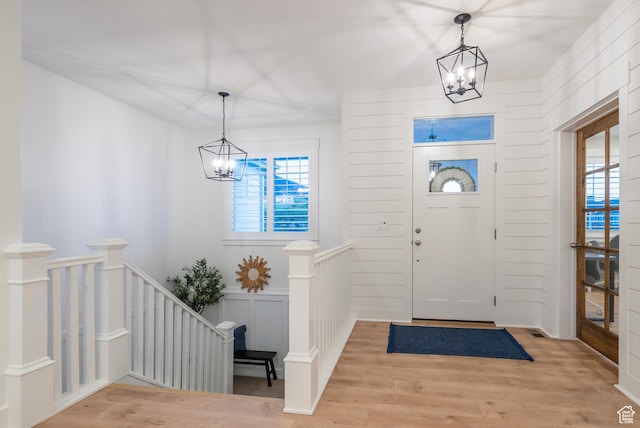 entryway with a chandelier and light wood-type flooring