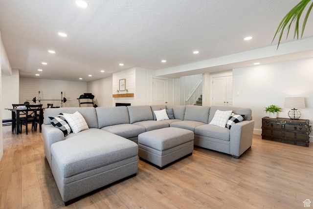 living room with stairway, light wood-style floors, and recessed lighting