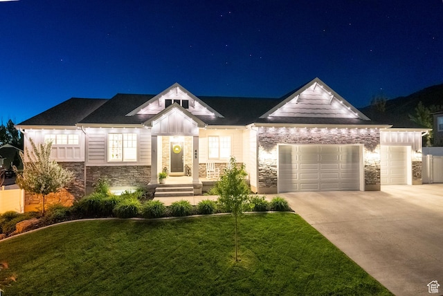 view of front facade featuring stone siding, an attached garage, a lawn, concrete driveway, and board and batten siding