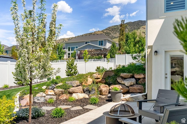 view of yard with a fire pit, fence, and a mountain view