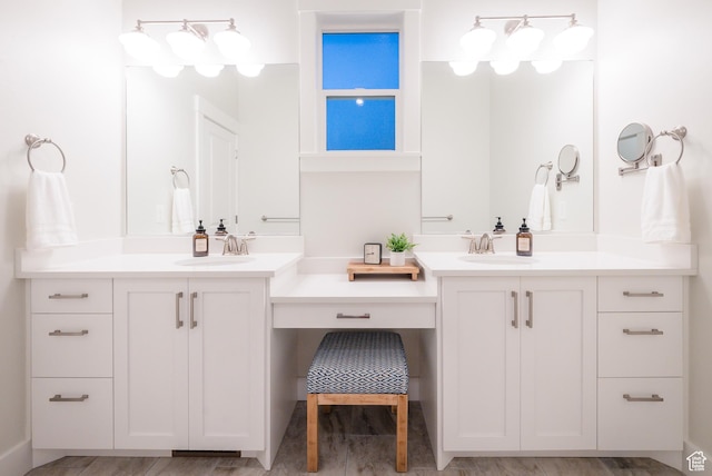 full bathroom with two vanities and wood finished floors