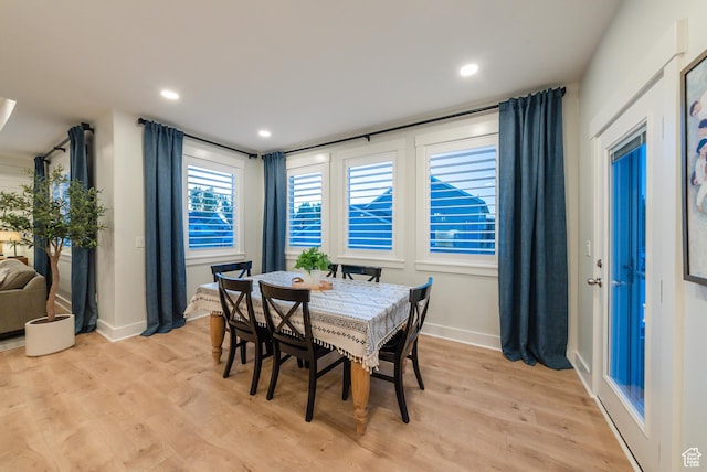 dining area featuring light wood-style flooring, baseboards, and recessed lighting