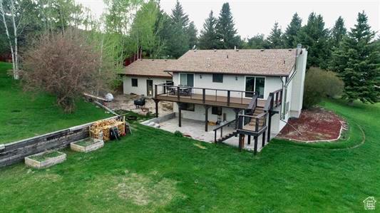 1204 Nashua Cir, Soda Springs, ID 83276 - back of house with a wooden deck, a chimney, a patio, and a yard
