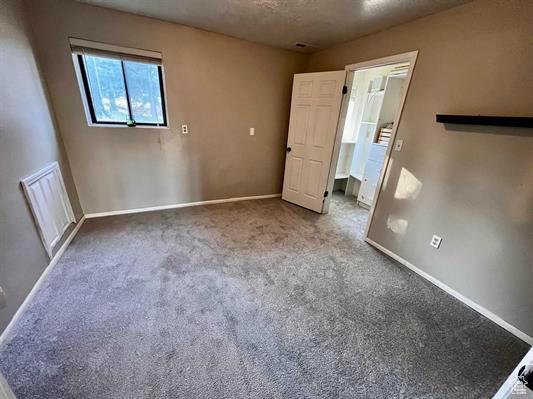 1204 Nashua Cir, Soda Springs, ID 83276 - spare room featuring baseboards and carpet flooring