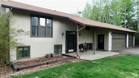 1204 Nashua Cir, Soda Springs, ID 83276 - view of front of home featuring an attached garage, a patio, asphalt driveway, and a front yard