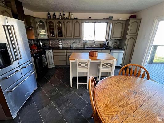 1204 Nashua Cir, Soda Springs, ID 83276 - kitchen with appliances with stainless steel finishes, backsplash, a sink, and dark countertops