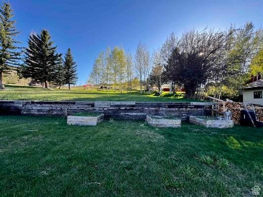 1204 Nashua Cir, Soda Springs, ID 83276 - view of green lawn featuring a garden